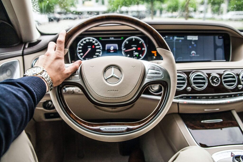 man-wearing-watch-touches-mercedes-benz-steering-wheel