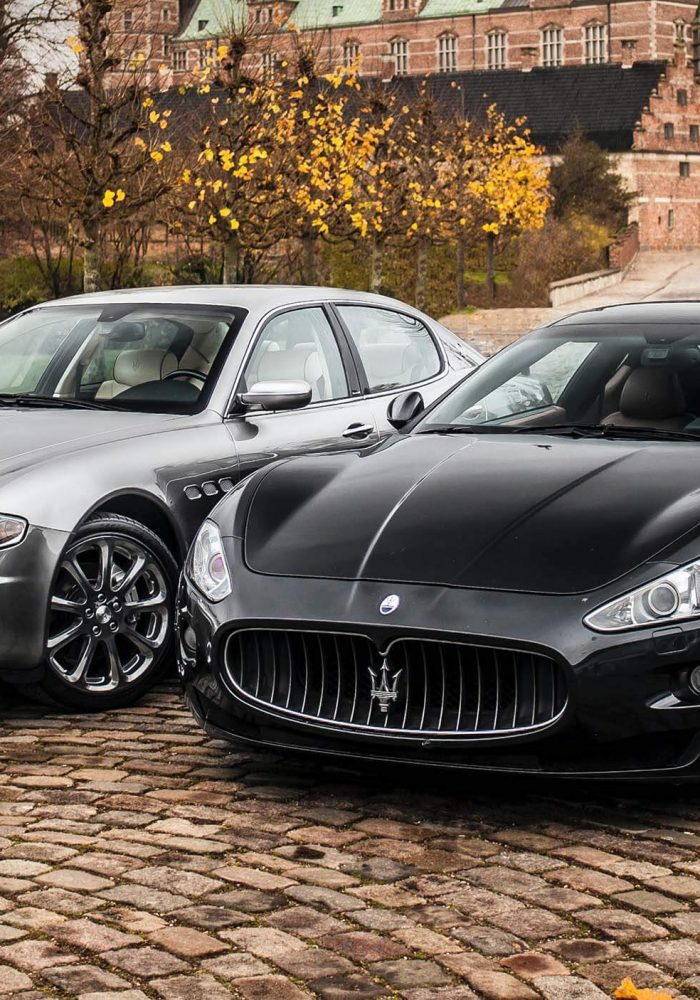 two-grey-and-black-maseratis-parked-on-cobblestones